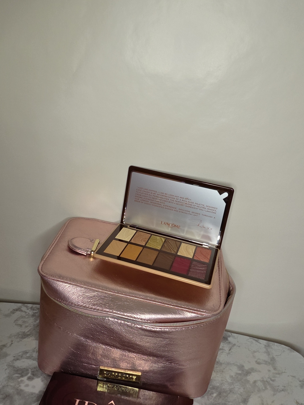 Lancome. Travel case for metallic pink makeup. Along with a palette of new shado